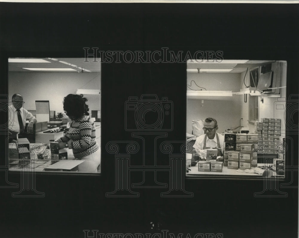 1974 Press Photo Imported fishing reels being packaged at Sears trade zone.