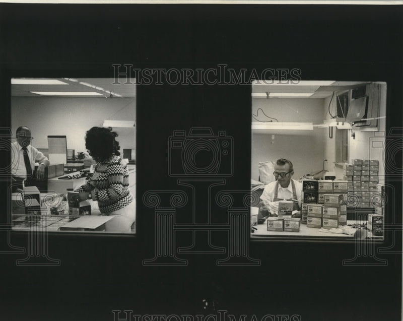 Load image into Gallery viewer, 1974 Press Photo Imported fishing reels being packaged at Sears trade zone.

