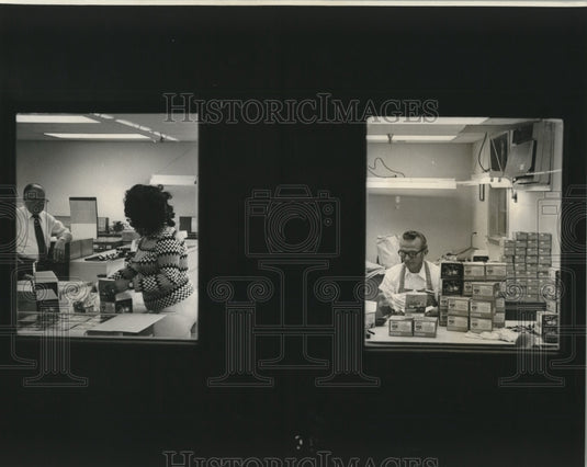 1974 Press Photo Imported fishing reels being packaged at Sears trade zone.