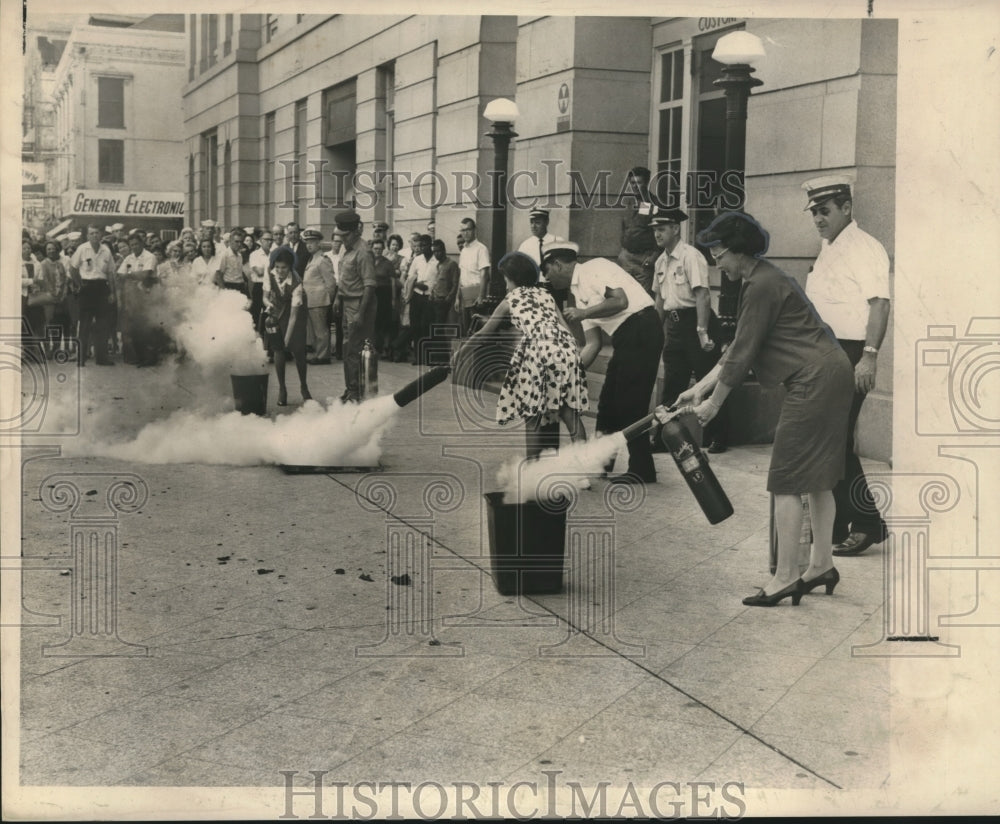 1966 Press Photo Custom House employees learn to extinguish waste basket fires.- Historic Images