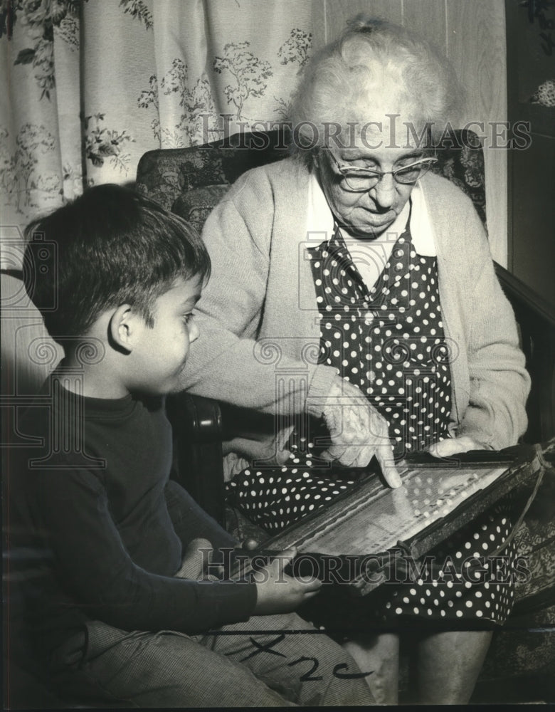 Load image into Gallery viewer, 1968 Press Photo Mrs. Darius Fontenot reads Chachere family record to Devlin
