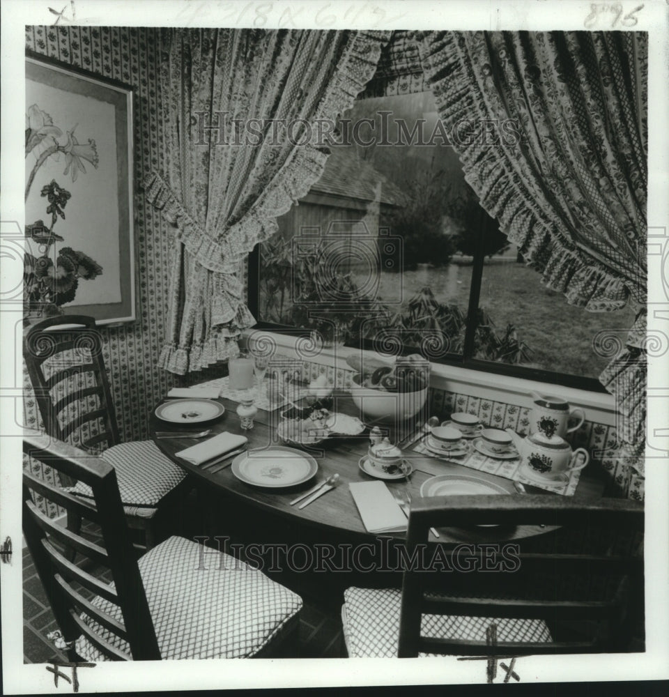 1971 Press Photo Breakfast area with checked padded chairs and flower painting