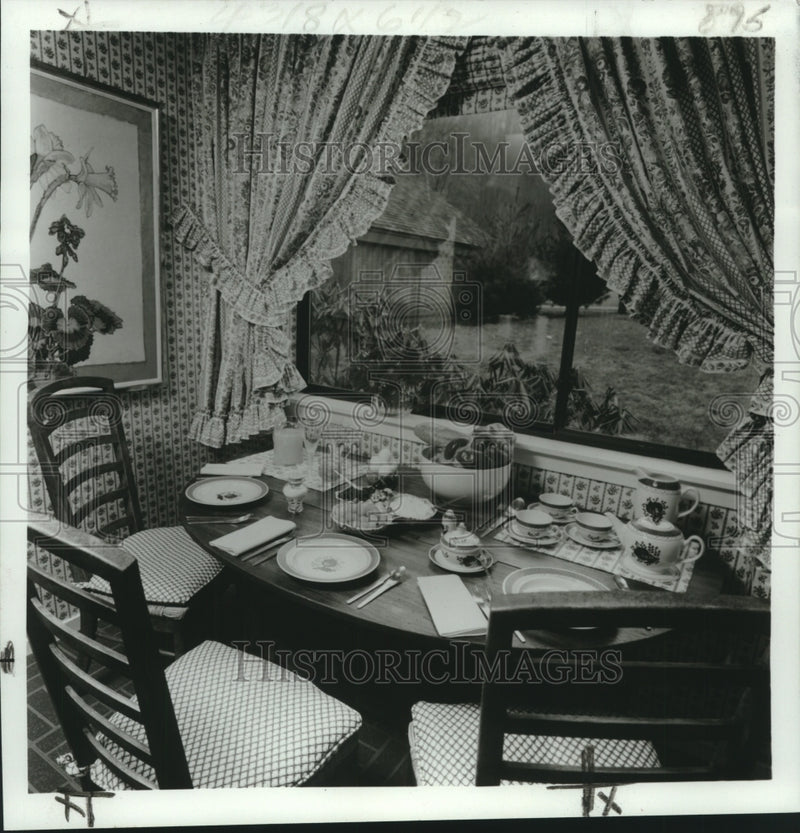 Load image into Gallery viewer, 1971 Press Photo Breakfast area with checked padded chairs and flower painting
