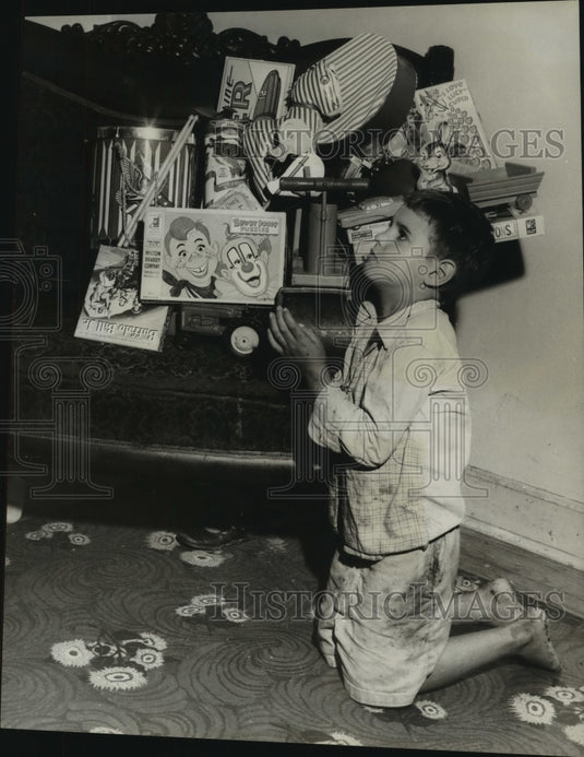 1957 Press Photo David Garcia saying his prayers among his toys - nob16477