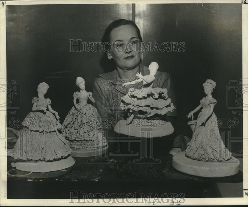 Load image into Gallery viewer, 1953 Press Photo Bonnie Fleischmann holds up one of her figurines, a ballerina
