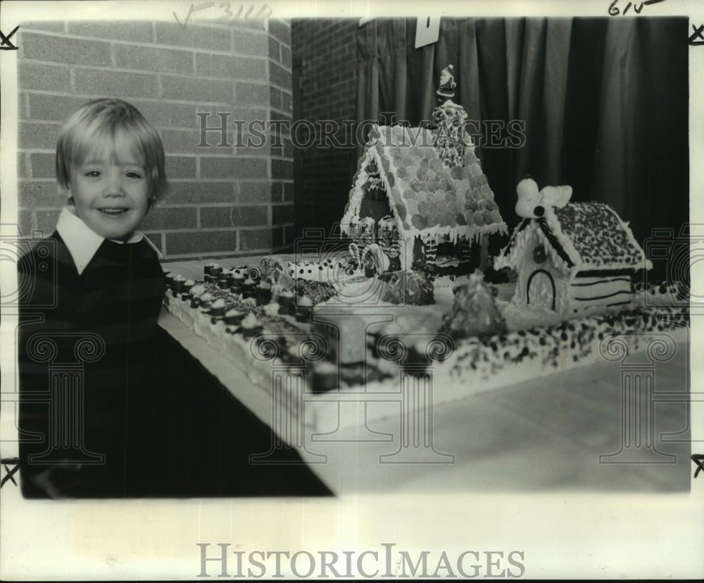 1977 Press Photo John Taylor admires the gingerbread houses made by his family- Historic Images