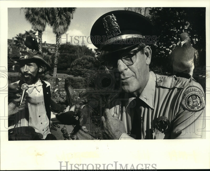 Load image into Gallery viewer, 1983 Press Photo Officer H.J. Vanderbrook with bird feeder James Greet
