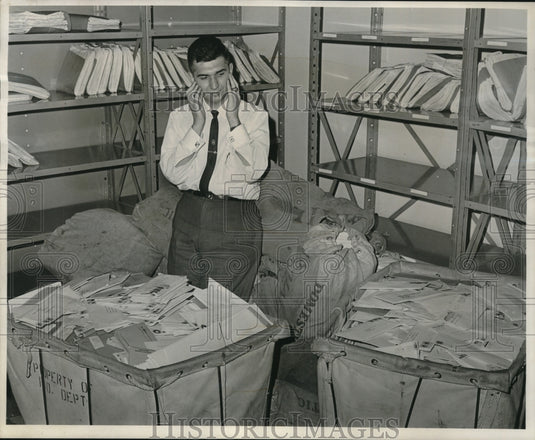 1964 Press Photo Mail clerk surrounded by Internal Revenue income tax returns- Historic Images