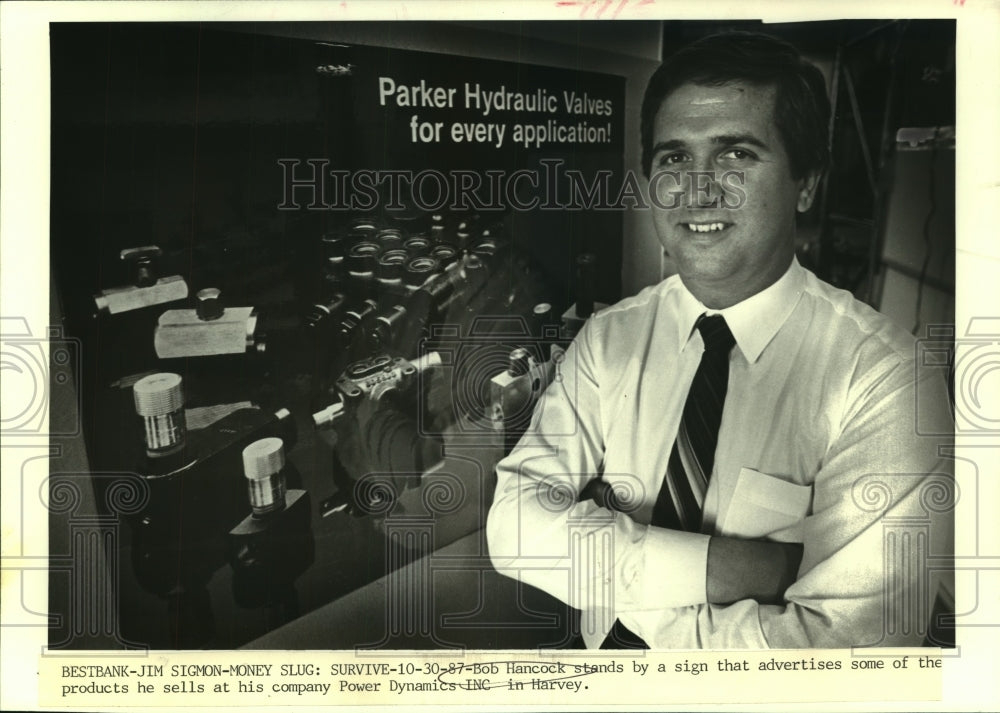 1987 Press Photo Bob Hancock stands by an advertisement sign for his company.- Historic Images