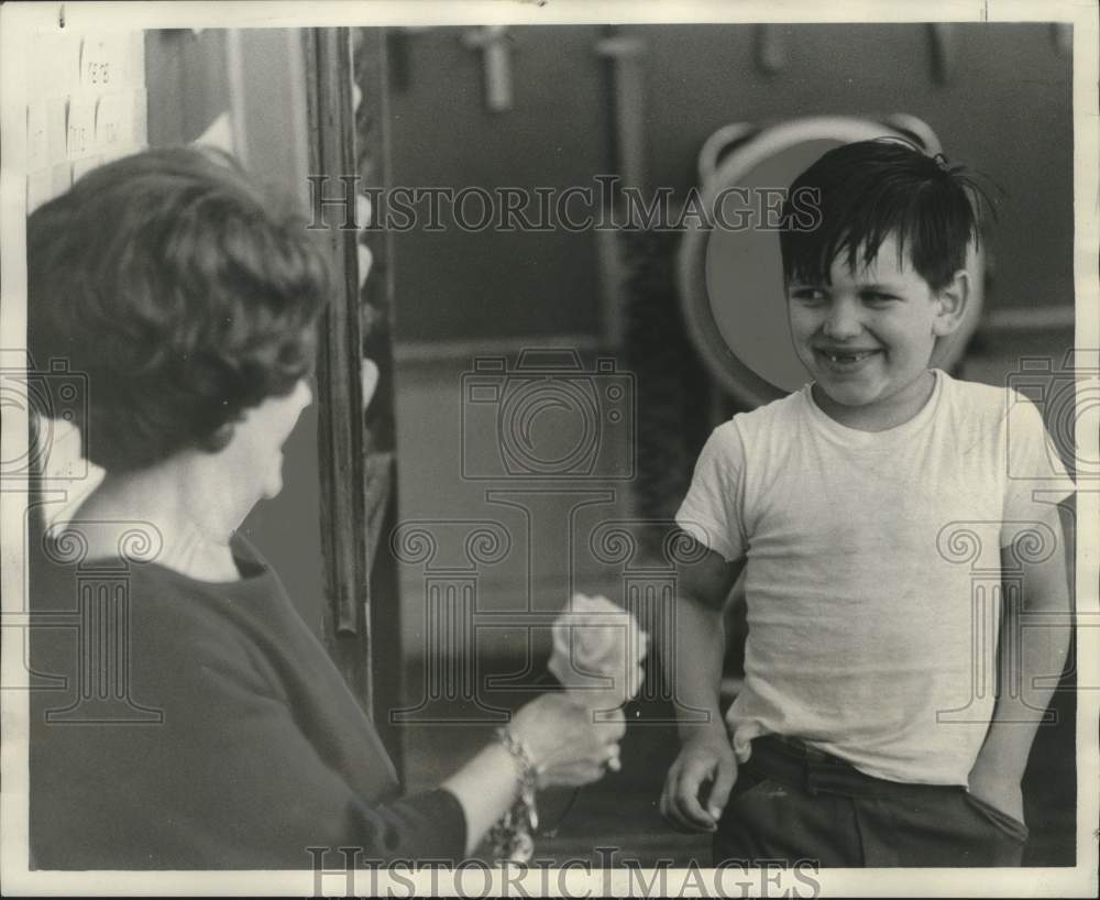 1974 Press Photo Student bringing his teacher a rose and a snaggle-tooth grin.- Historic Images