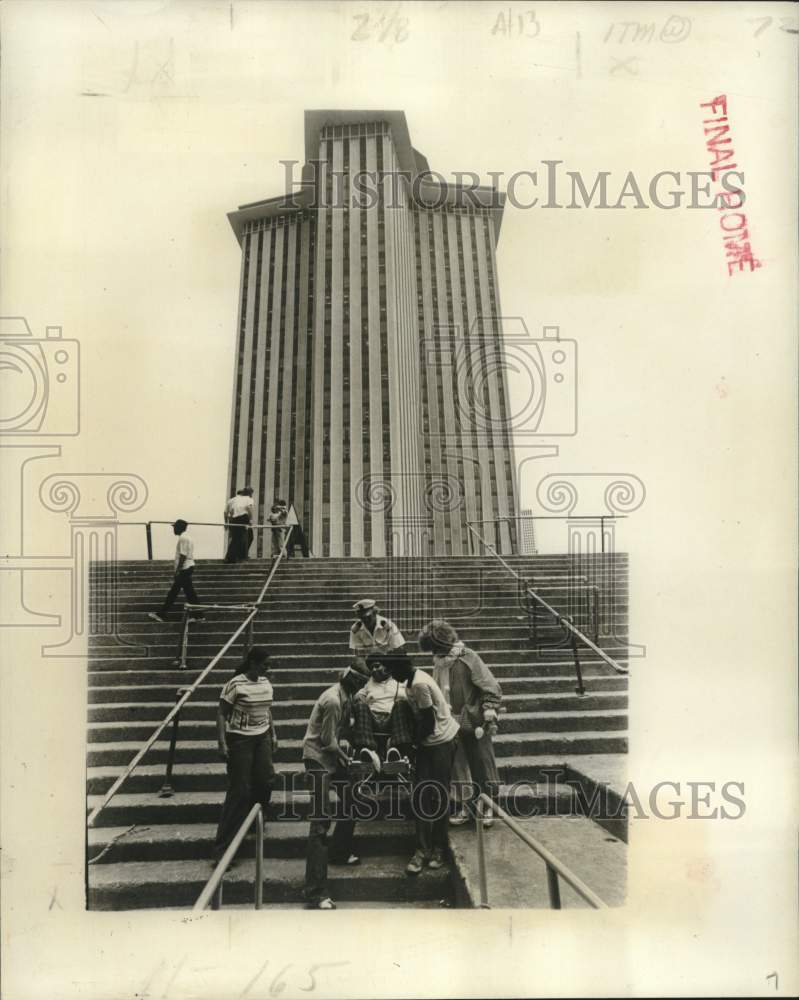Load image into Gallery viewer, 1977 Press Photo Youngster gets help at Canal Street to get aboard MV Commodore
