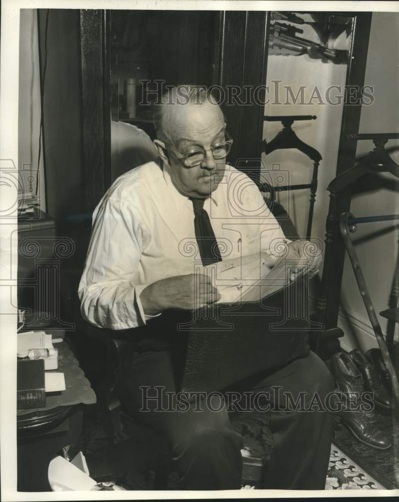 1959 Press Photo Dr. James Glenderson looks through his records as surgeon