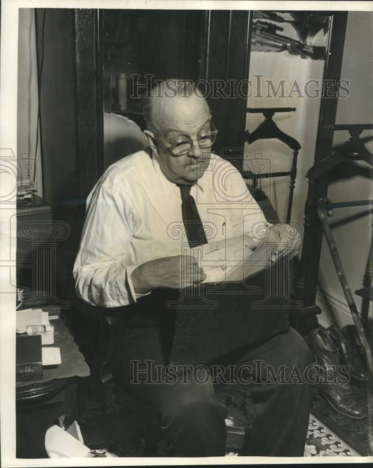 1959 Press Photo Dr. James Glenderson looks through his records as surgeon