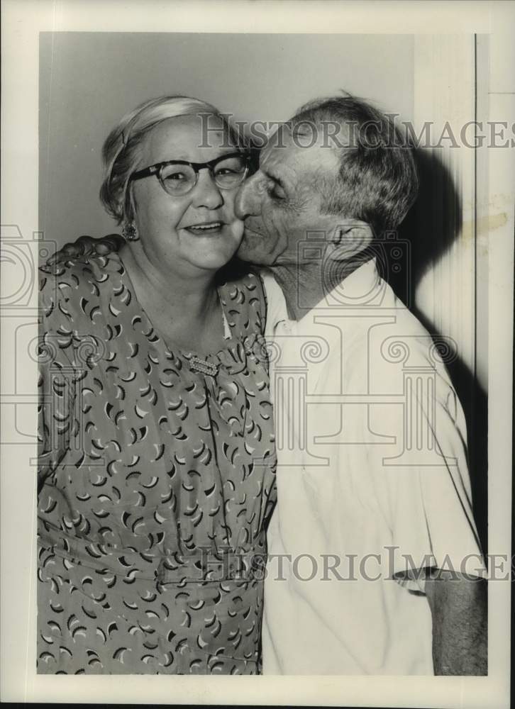 Load image into Gallery viewer, 1954 Press Photo George LeBlanc Kisses Mrs. Mary Bertrand On The Cheek
