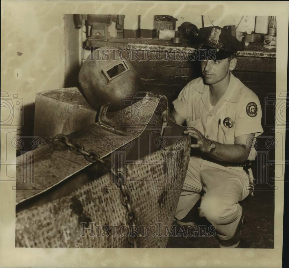 1956 Press Photo Joseph Le Blanc of crash truck crew looks at exploded tank