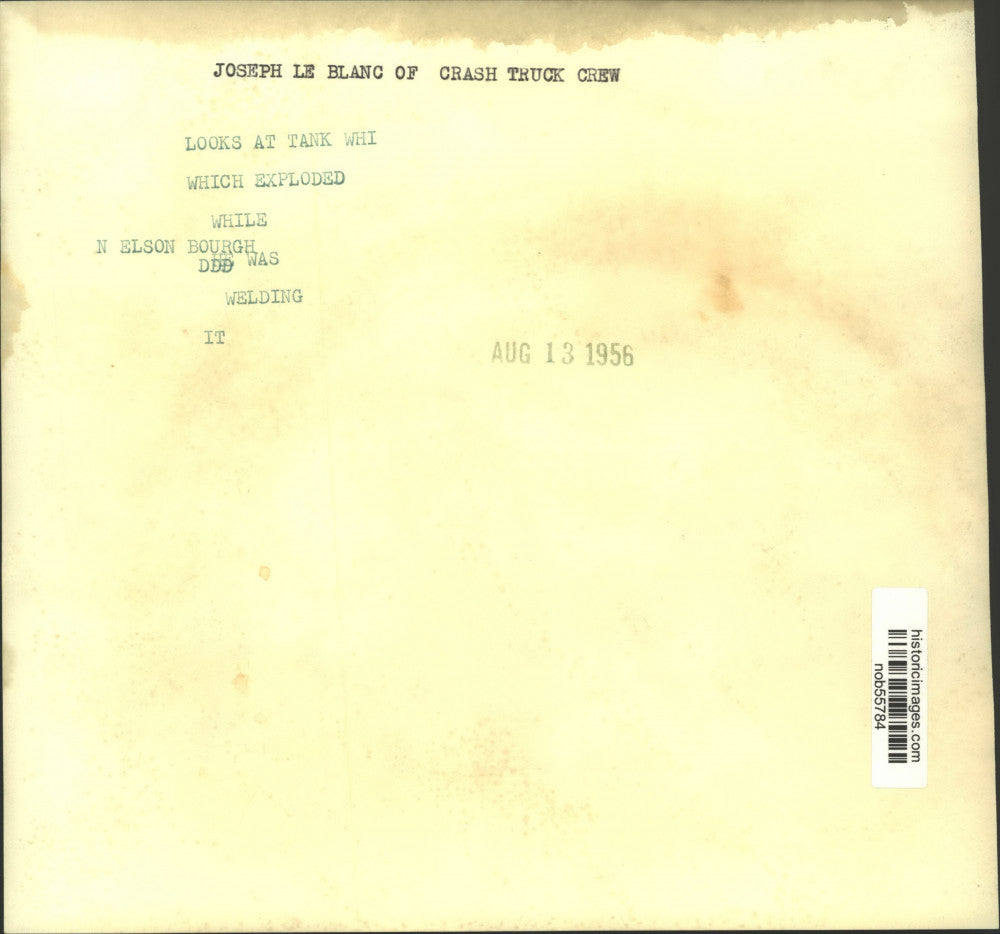 1956 Press Photo Joseph Le Blanc of crash truck crew looks at exploded tank