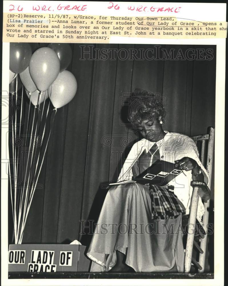 1987 Press Photo Anna Lumar looks over an Our Lady of Grace yearbook in a skit- Historic Images