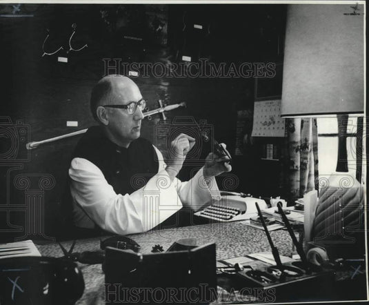 1973 Press Photo Father Remig examines spur from unusual collection - nob59899