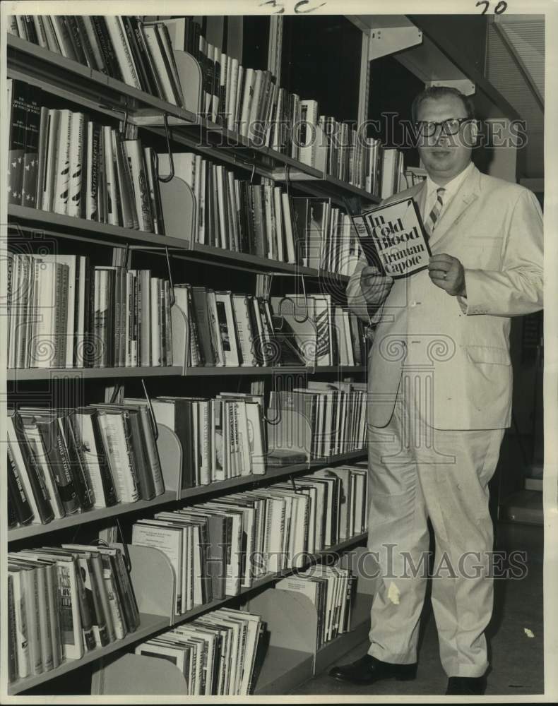 Load image into Gallery viewer, 1966 Press Photo New Orleans Librarian Guenter Jansen with most wanted book.
