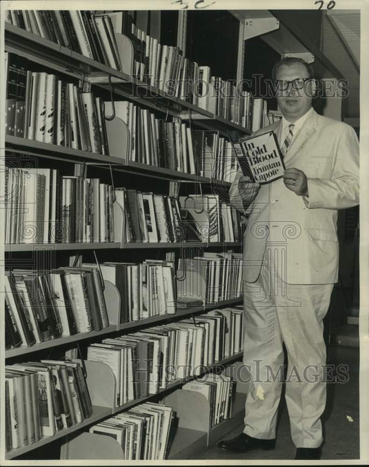 1966 Press Photo New Orleans Librarian Guenter Jansen with most wanted book.