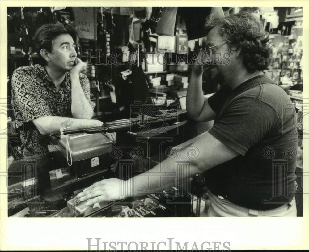 1994 Press Photo Calvin Oyler buying an MAK 90 at Jewelry and Sporting Goods