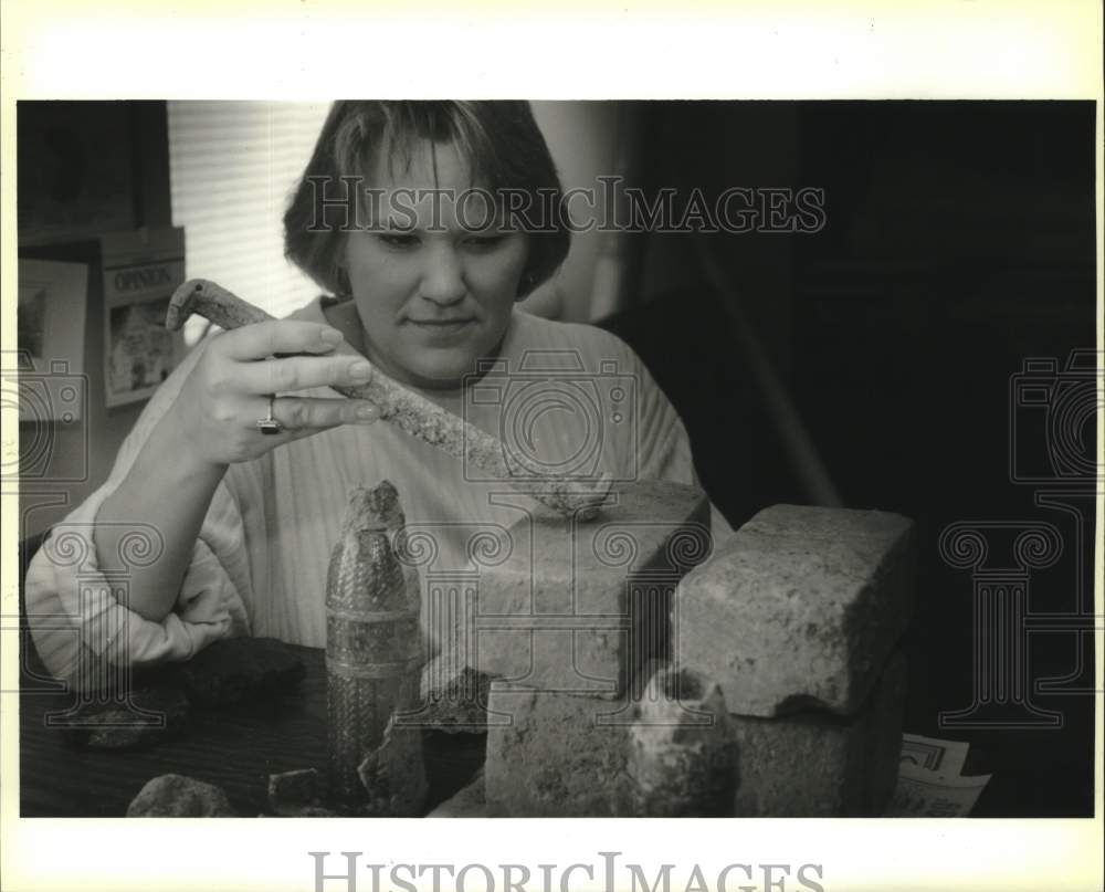 Press Photo Renee Roberts with items found during excavation at State Capitol- Historic Images