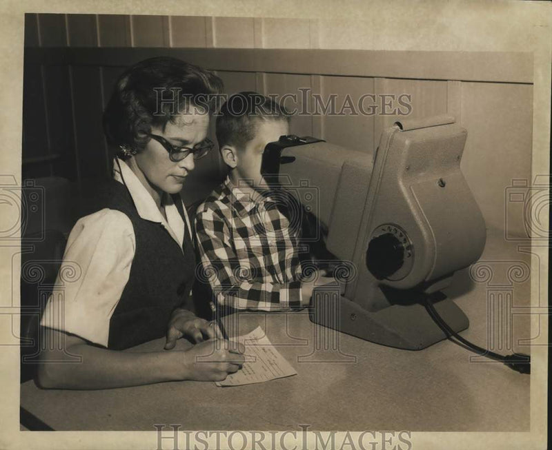 Load image into Gallery viewer, 1967 Press Photo Mrs. Joyce Burkhart marks eye exam result of Chris Patterson
