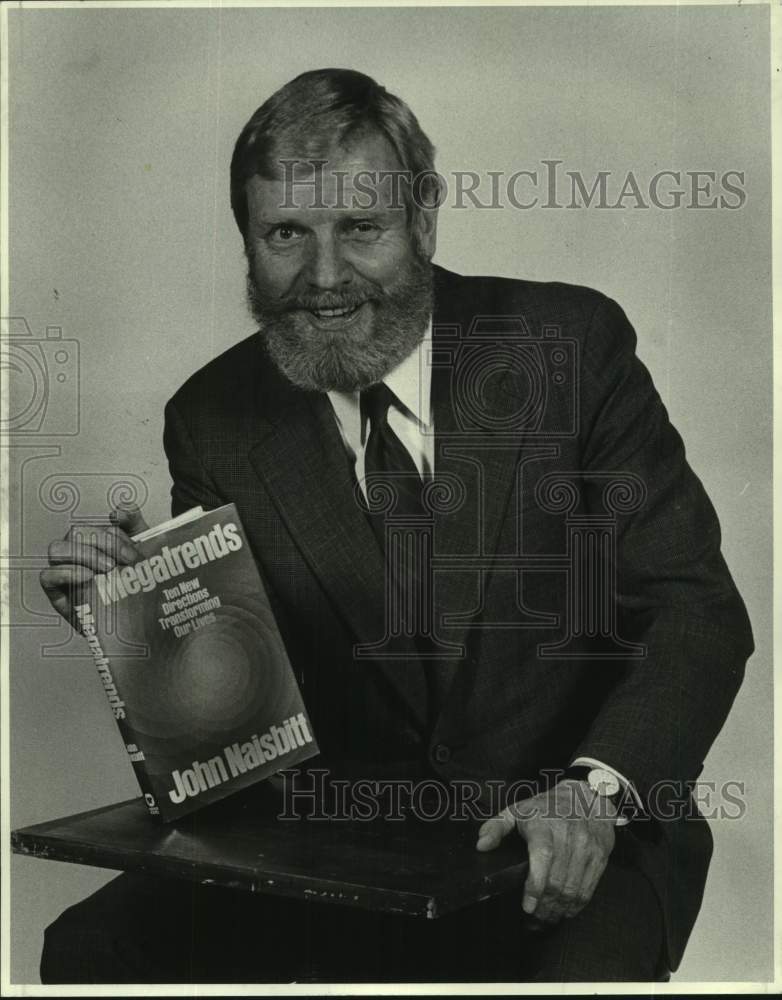 1983 Press Photo Writer John Naisbitt shows his book &quot;Megatrends&quot;- Historic Images