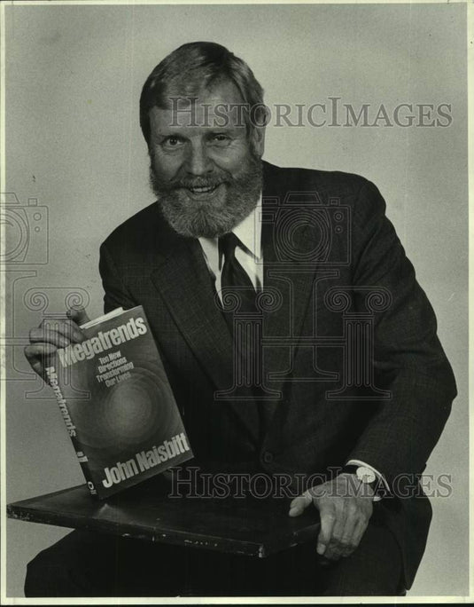 1983 Press Photo Writer John Naisbitt shows his book "Megatrends"- Historic Images