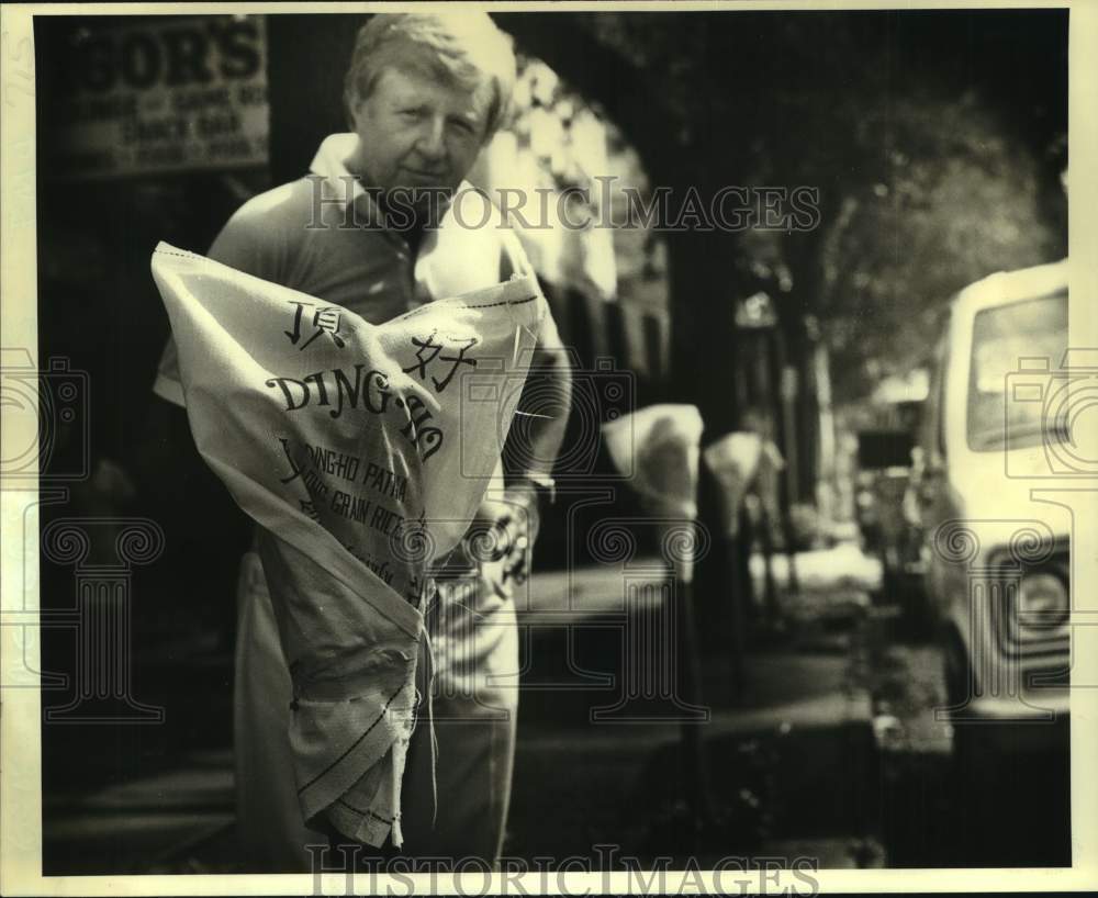 1981 Press Photo Lloyd Murray holds cover with Oriental language at St. Charles- Historic Images