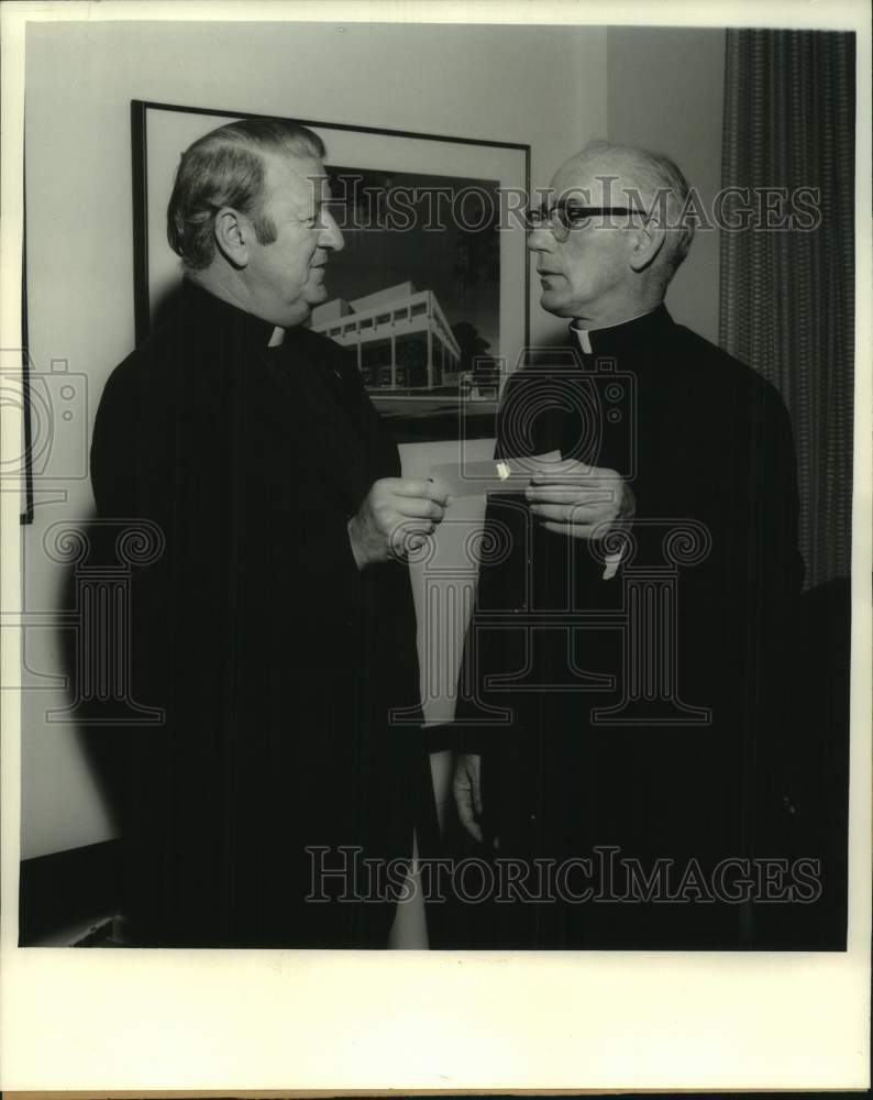 Press Photo Rev. H.R. Montecino presents check to Very Reverend Michael Kennelly- Historic Images