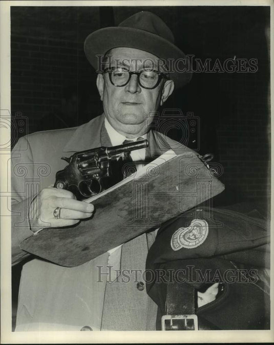 1964 Press Photo Orleans Parish Investigator Sam Moran looks at caliber revolver