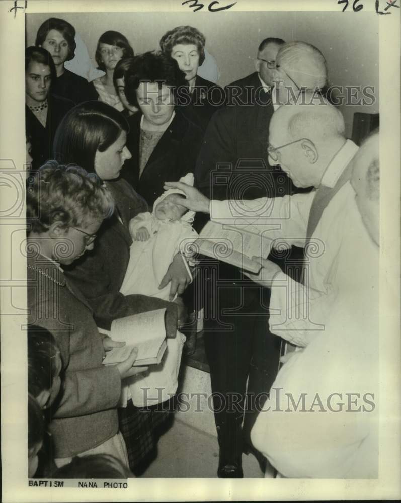 1965 Press Photo Dom Meunier of St. Armand le Bruges baptizes his grandchild