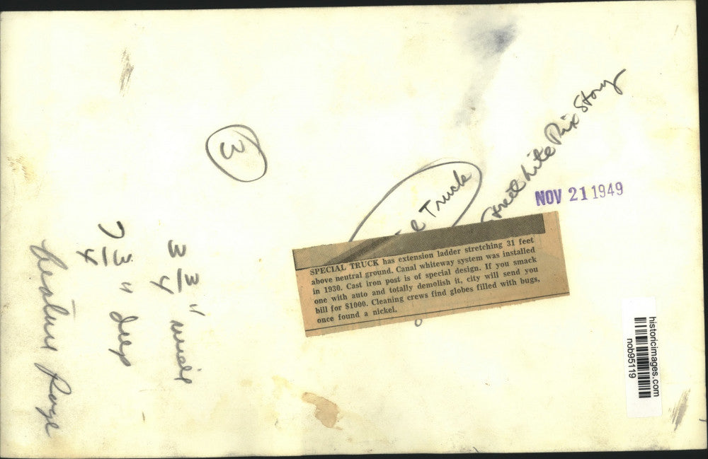 1949 Press Photo Cleaning crews on extended ladder to clean cast iron post