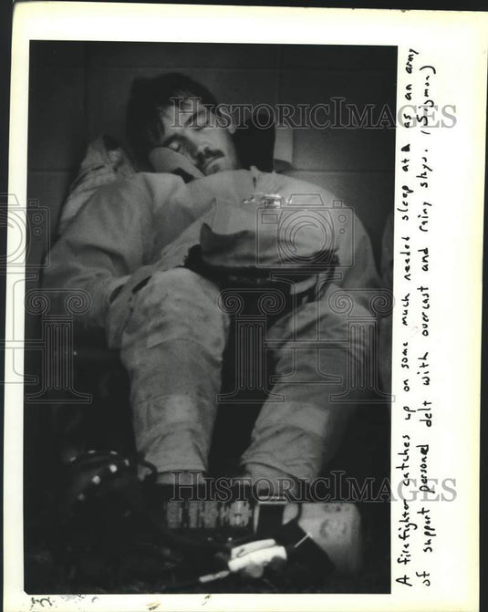 1988 Press Photo Firefighter catches up on sleep, Oakland Alien Detention Center- Historic Images