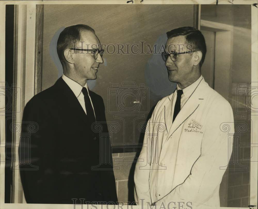 1965 Press Photo Dr. Harry Basomb discuss subjects to be taken by Dr. Thomas Mou- Historic Images