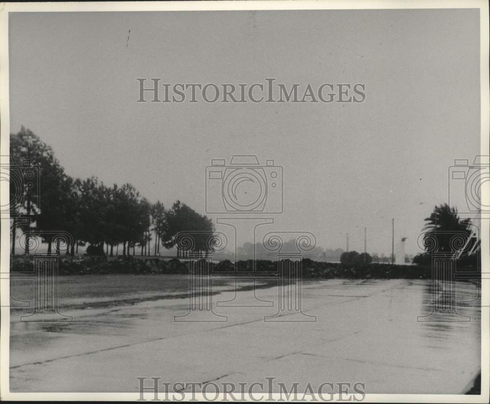 1965 Press Photo Rain And Wind-Swept Roadway Near Levee - nob98480
