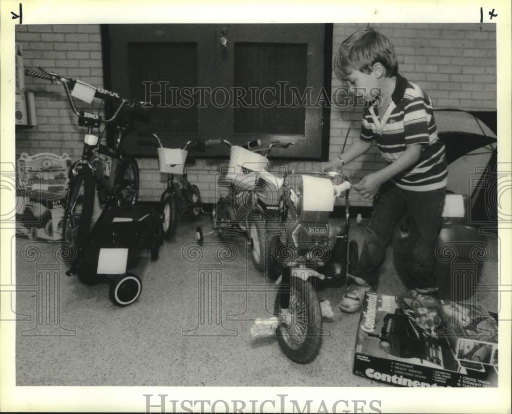 1990 Press Photo James Salande checks out a bike at Operation Merry Christmas- Historic Images