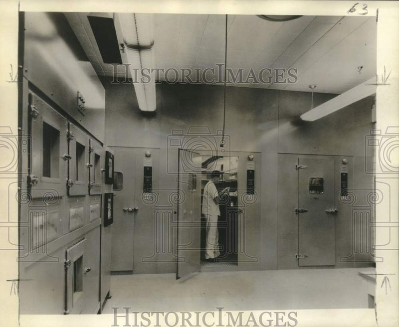 Load image into Gallery viewer, 1958 Press Photo Researcher Checks Compound Stored In Drug Stability Cold Room
