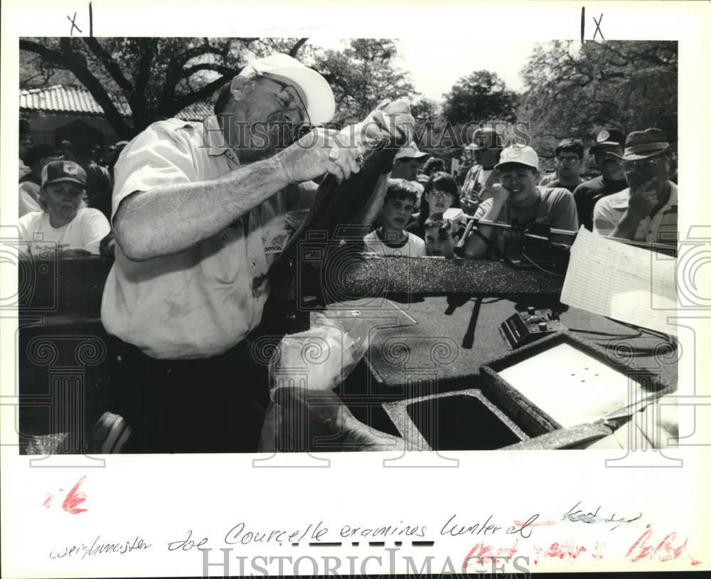 Press Photo Weigh master Joe Courcelle Examines Fish While Crowd Watches- Historic Images