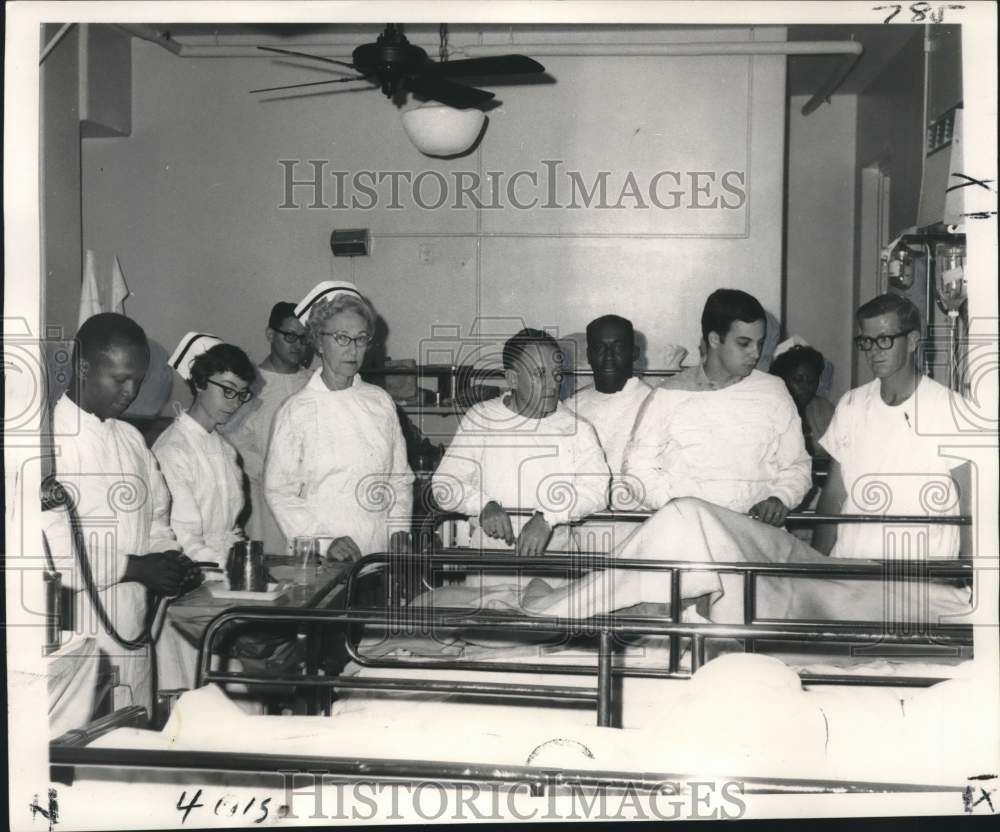 1968 Press Photo Oil rig disaster victim surrounded by Health Service team