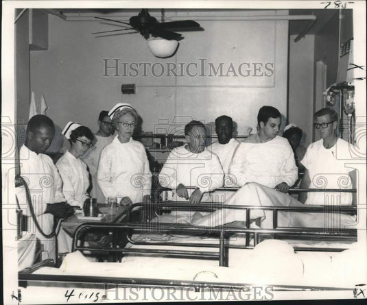 1968 Press Photo Oil rig disaster victim surrounded by Health Service team