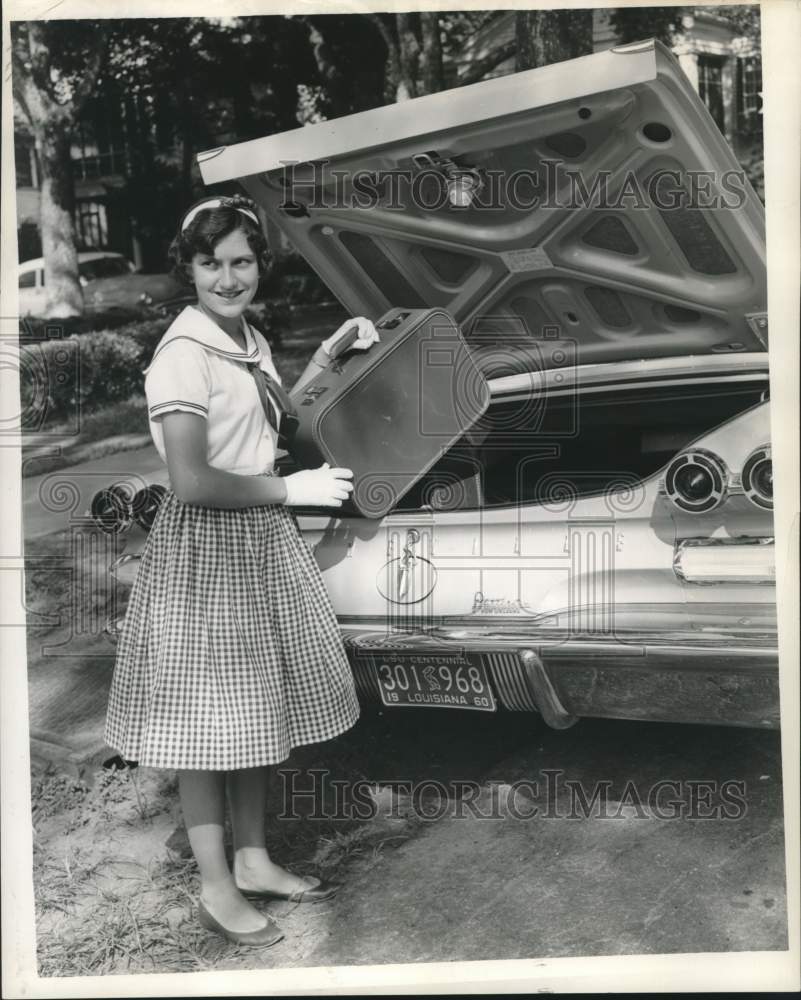 1967 Press Photo Suzanne Pavy puts suitcase into car in New Orleans - noc01706