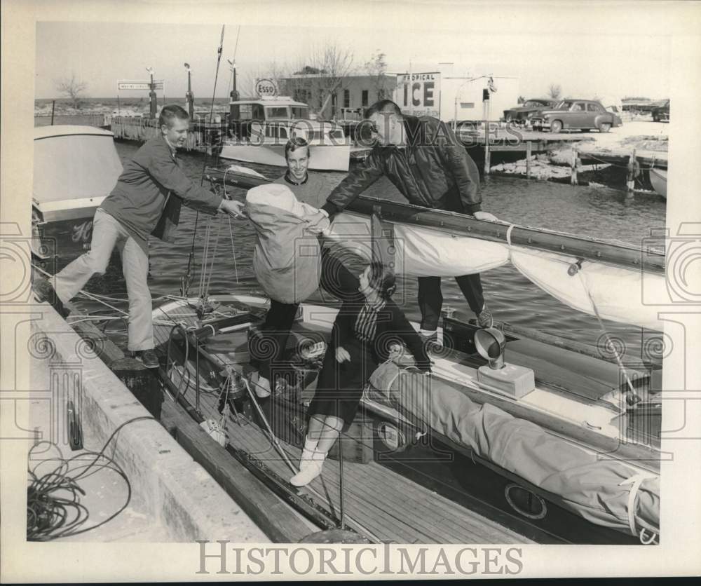 1958 Press Photo Group of friends loads cargo before shipping out - noc02099