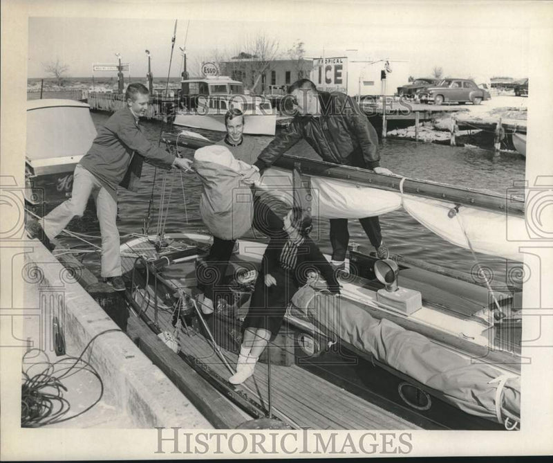 Load image into Gallery viewer, 1958 Press Photo Group of friends loads cargo before shipping out - noc02099
