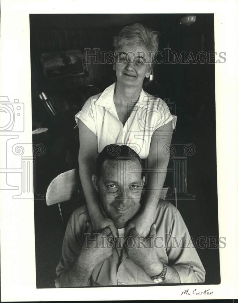 Load image into Gallery viewer, 1988 Press Photo Heart recipient Wayne Perilloux gets a hug from his wife, Iris
