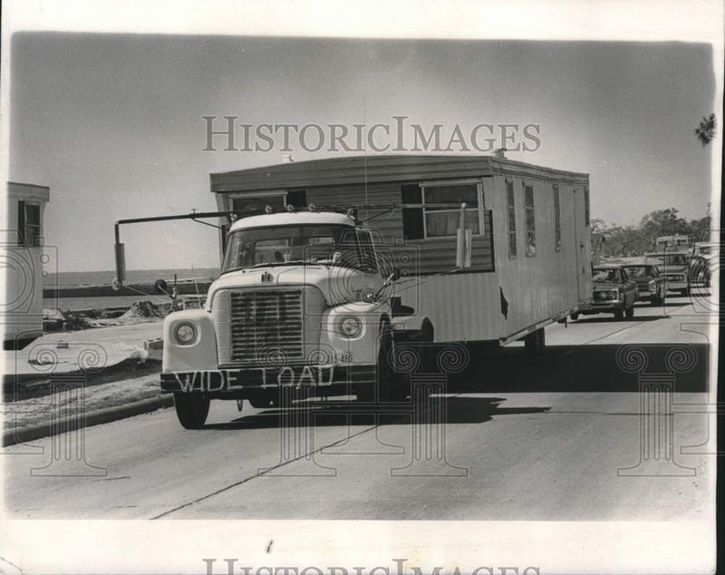 Load image into Gallery viewer, 1969 Press Photo Truck brings trailer into Pass Christian along Highway 90
