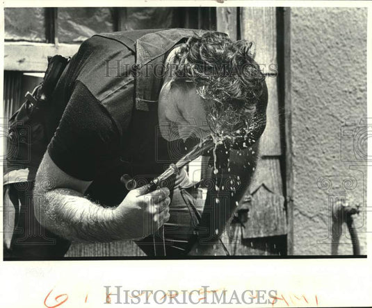 1984 Press Photo SWAT team member hoses tear gas fumes from his eyes - noc05535