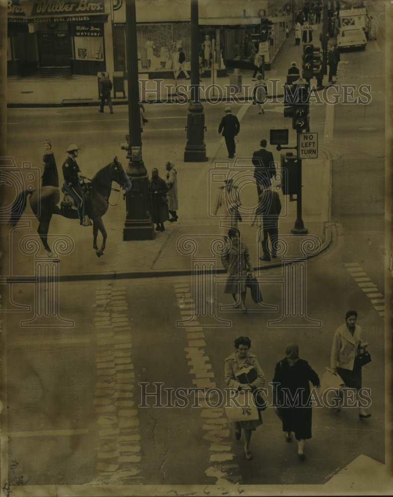 1964 Press Photo Patrolman Richard Condon Jr. watches pedestrians at Canal St.- Historic Images