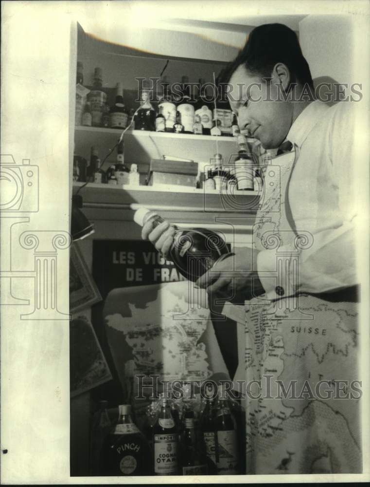 Load image into Gallery viewer, 1968 Press Photo Poister with bottle of wine in his pantry - noc05790
